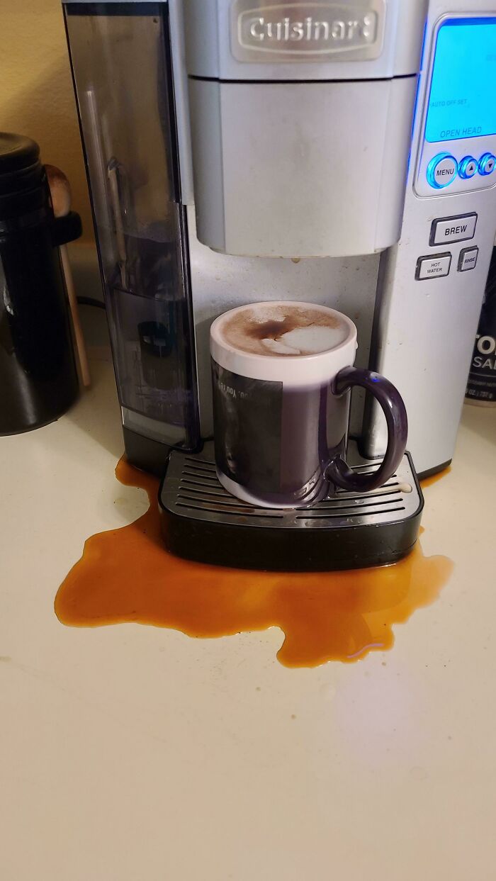 Coffee machine overflowing, spilling coffee onto the counter, a weird upside-down thing that needs fixing immediately.