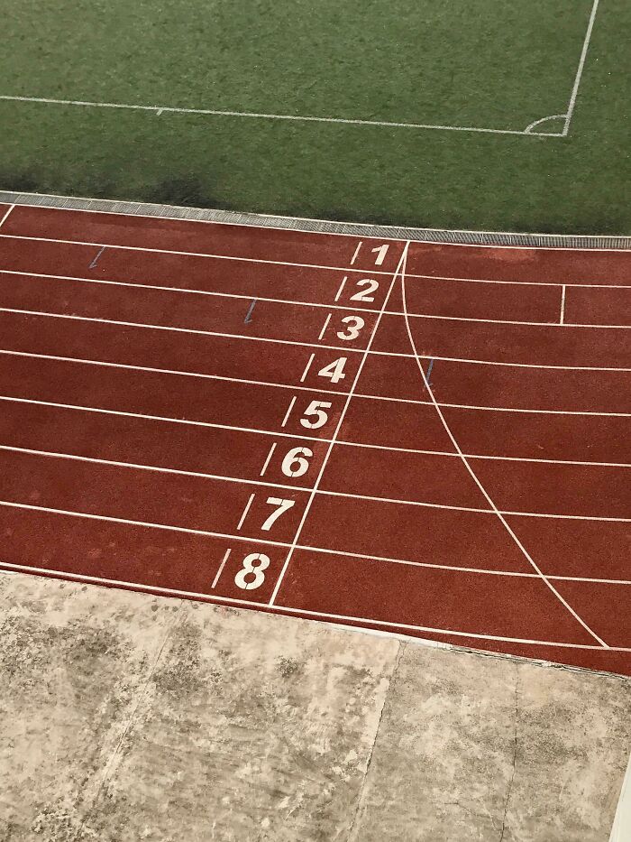 An upside-down view of a running track with lane numbers 1-8, next to a soccer field. Things that might make you want to fix them.