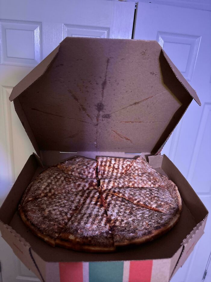 An upside-down pizza in a box, with the cheese stuck to the lid. A weird upside-down thing to fix immediately!