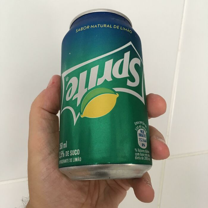 A hand holding an upside-down Sprite can, illustrating the weird upside-down things concept.