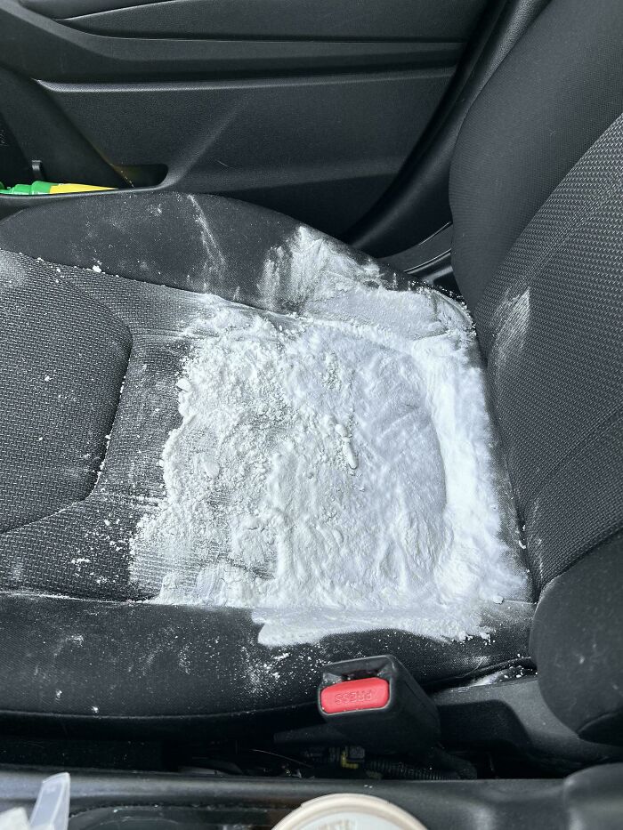 Car seat covered in white powder spill, illustrating unusual real-life stories that sound made up but are true.