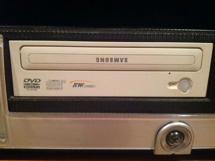 An upside-down Samsung DVD RW COMBO drive, displaying the brand name mirrored. This weird upside-down thing might need fixing.