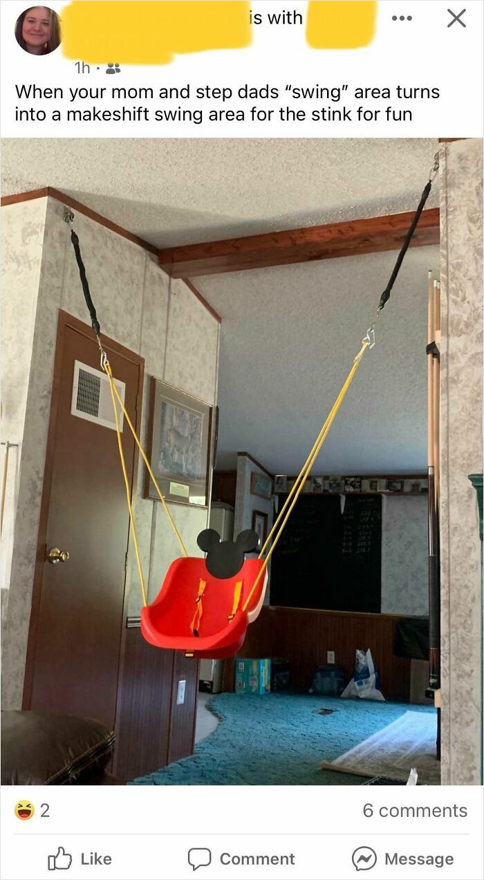 A red Mickey Mouse baby swing hangs indoors, suspended from the ceiling. Cringey parents created this makeshift play area.