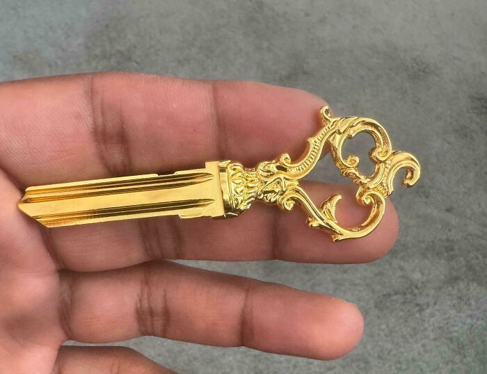 A close-up of a golden, ornate handmade key, a truly talented handmade project.