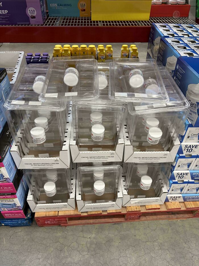 Display of facial moisturizing cream in anti-theft packaging, highlighting the insulting consumerism of securing low-value items.