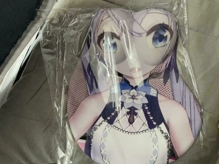 A mousepad with a distorted anime girl design, a funny you had one job fail.