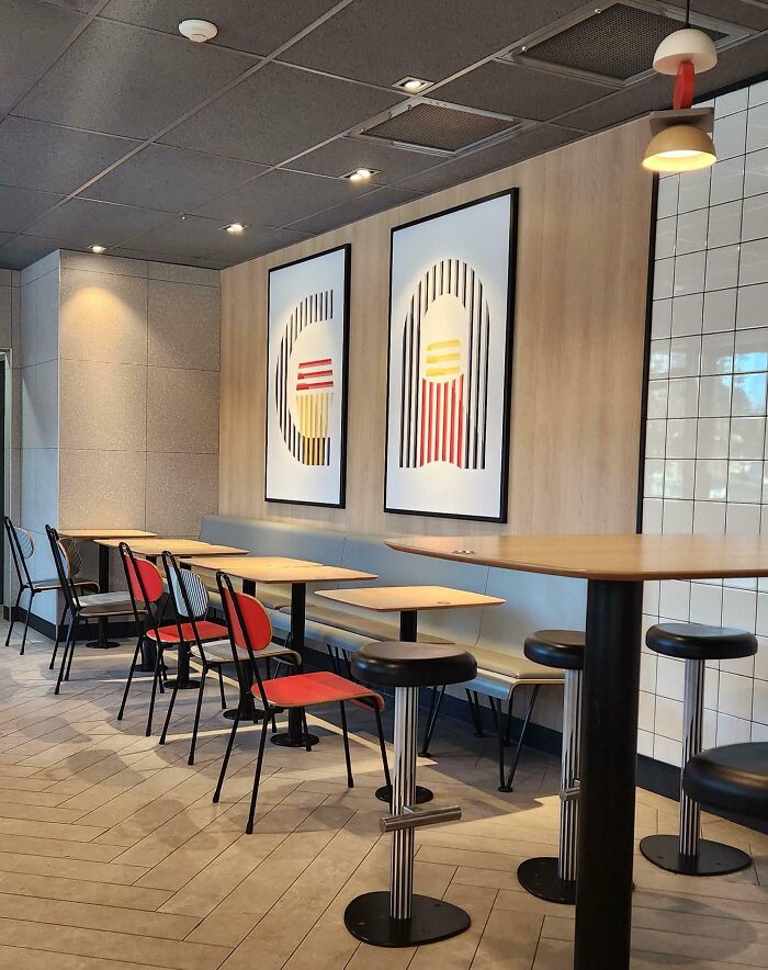 Empty modern cafe interior with chairs and tables, illustrating dystopian United States urban design trends.