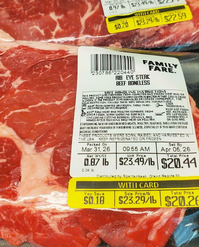 Close-up of rib eye steak price label showing high cost per pound, illustrating dystopian United States food prices.