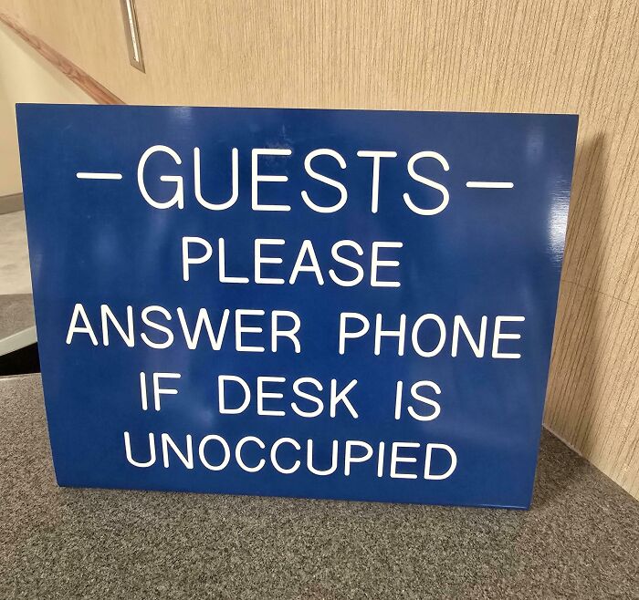 Funny confusing sign asking guests to answer the phone if the desk is unoccupied, showcasing humor in signs with bees theme.
