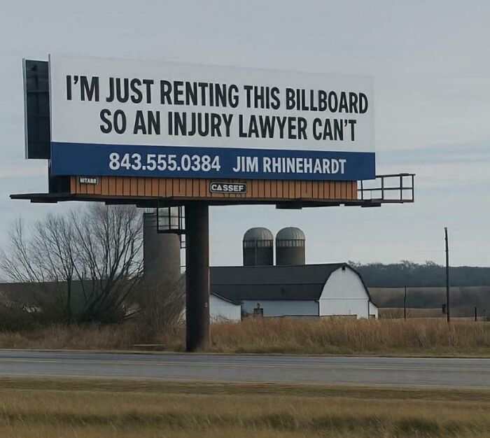 Funny and confusing sign on a rural billboard renting space to avoid injury lawyer advertisements.