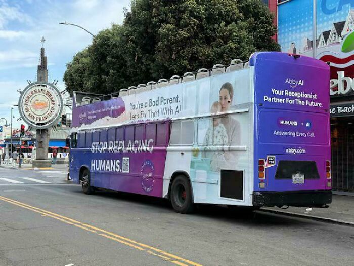 Bus with dystopian AI advertisement in urban street scene highlighting concerns about replacing humans with AI.