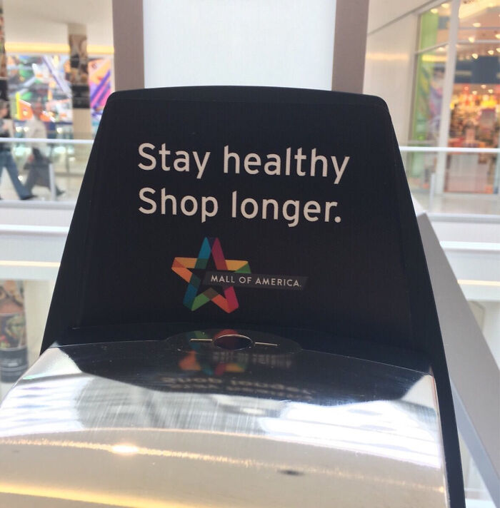Mall of America hand sanitizer dispenser with Stay healthy Shop longer text in a dystopian United States setting.