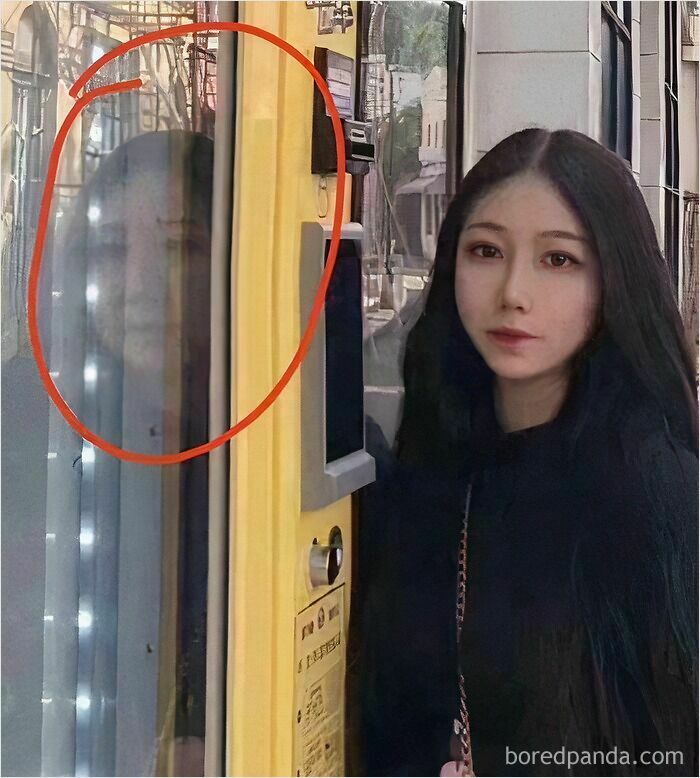 Young woman stands beside a yellow machine with a wild Instagram edit showing a distorted human face reflection.