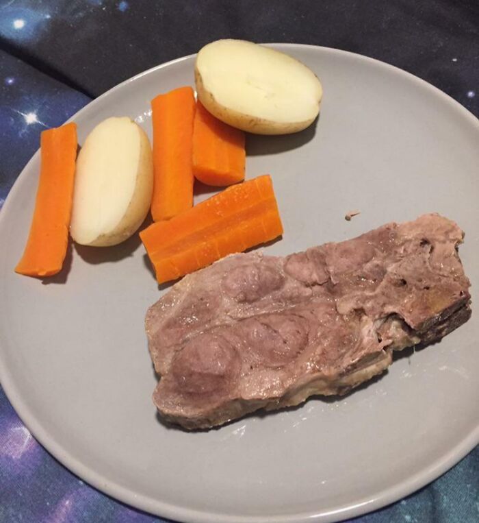 Overcooked meat with carrots and potatoes, resembling a bananasausage food crime.