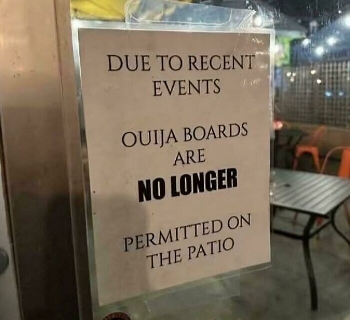 A sign reads "Ouija boards are no longer permitted on the patio," an example of oddly specific rules.