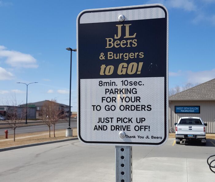 A JL Beers To Go sign with a very specific rule: 8min 10sec parking for pickup. This oddly specific rule inspires wonder.