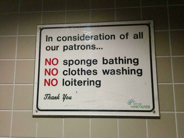 A sign listing oddly specific rules against sponge bathing, clothes washing, and loitering, making you wonder which idiot inspired them.