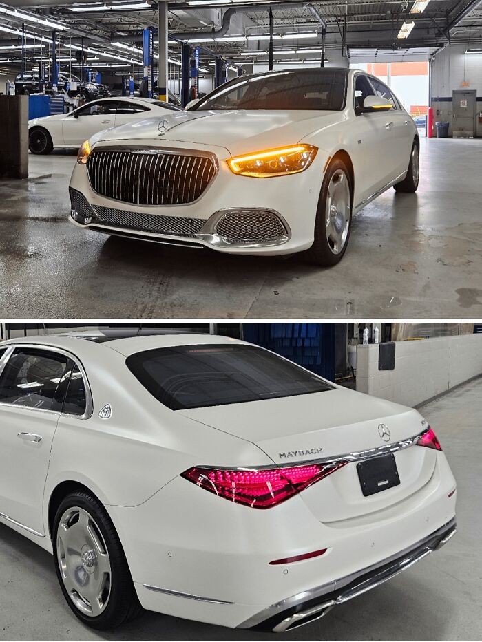 White Mercedes Maybach in a car mechanic workshop showing front and rear views with lights on, highlighting luxury vehicle details.