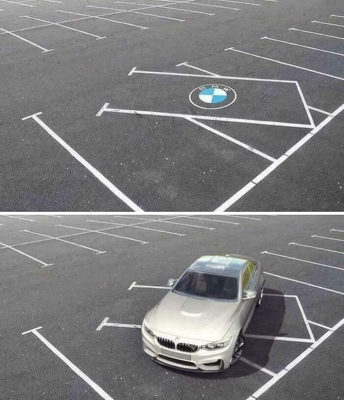 Confusing parking spot lines painted around a BMW logo and a car parked awkwardly in a mismarked parking space.