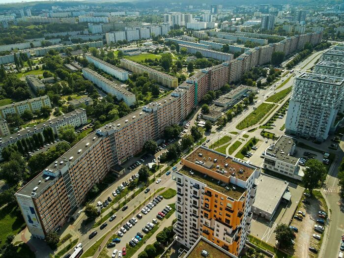 Aerial view of sprawling urban hell with dense apartment blocks and green spaces