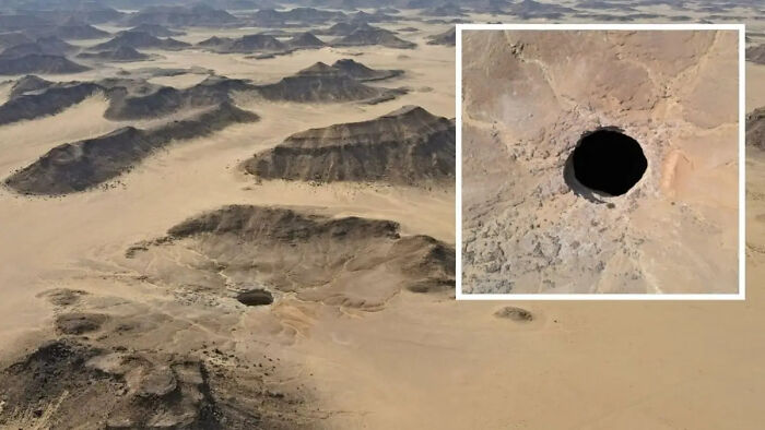 Aerial view of a mysterious desert hole surrounded by rocky terrain, illustrating urban myths and unexplained events.