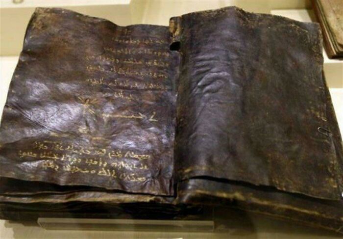 Ancient leather-bound manuscript with mysterious faded text, related to unknown events and urban myths.
