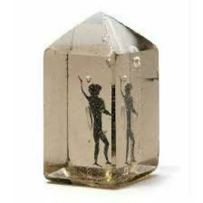 Small clear crystal with an ancient black figure inside, linked to mysterious events and urban myths unexplained.