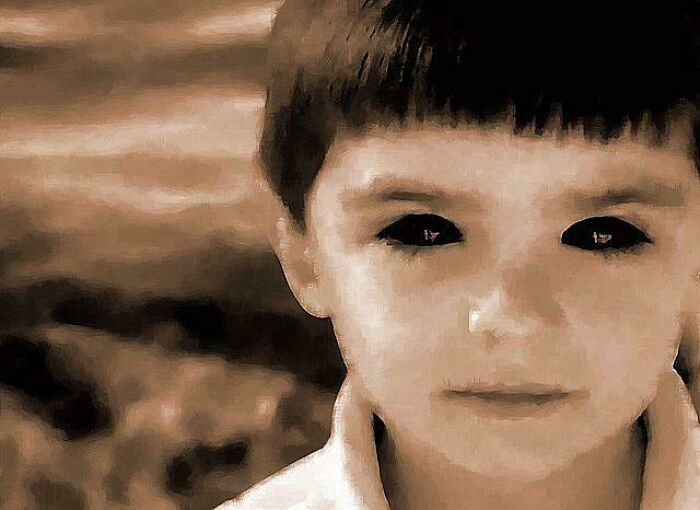 Young boy with black eyes in an eerie setting, representing mysterious events and urban myths with unknown truths.
