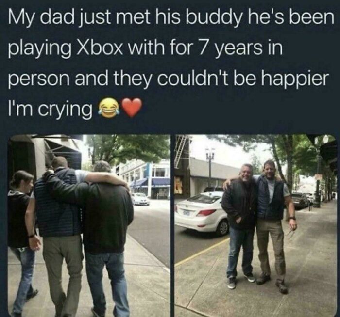 Two men hugging and smiling on a sidewalk, sharing a heartwarming moment of friendship and positivity.