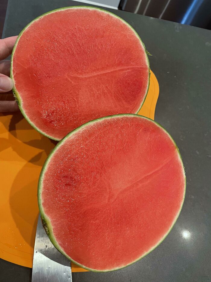 Two halves of a perfectly ripe, seedless watermelon on an orange cutting board. A satisfying picture for a gentle reset.
