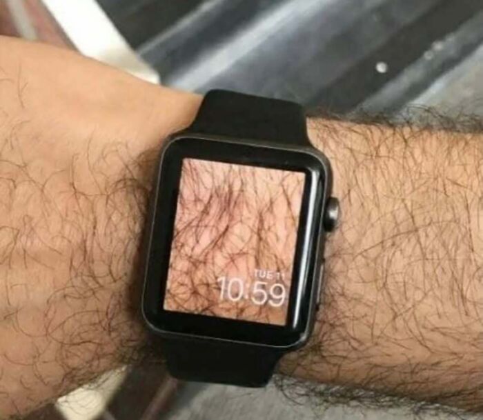 Smartwatch displaying hairy arm skin matching the wearer's arm, a confusing and unhinged visual trick.