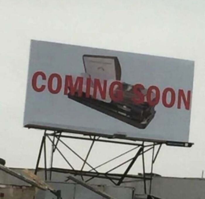 Billboard with a confusing image of a laptop and the words coming soon, showcasing unhinged and weird visuals.