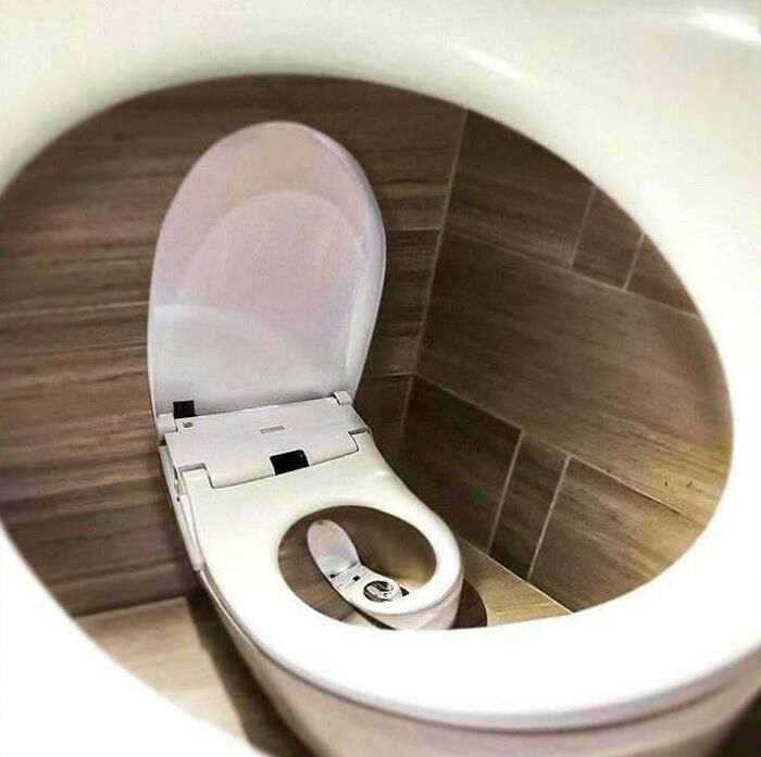 Toilet with a recursive design showing smaller toilets inside, a confusing and unhinged image where things only get weirder.