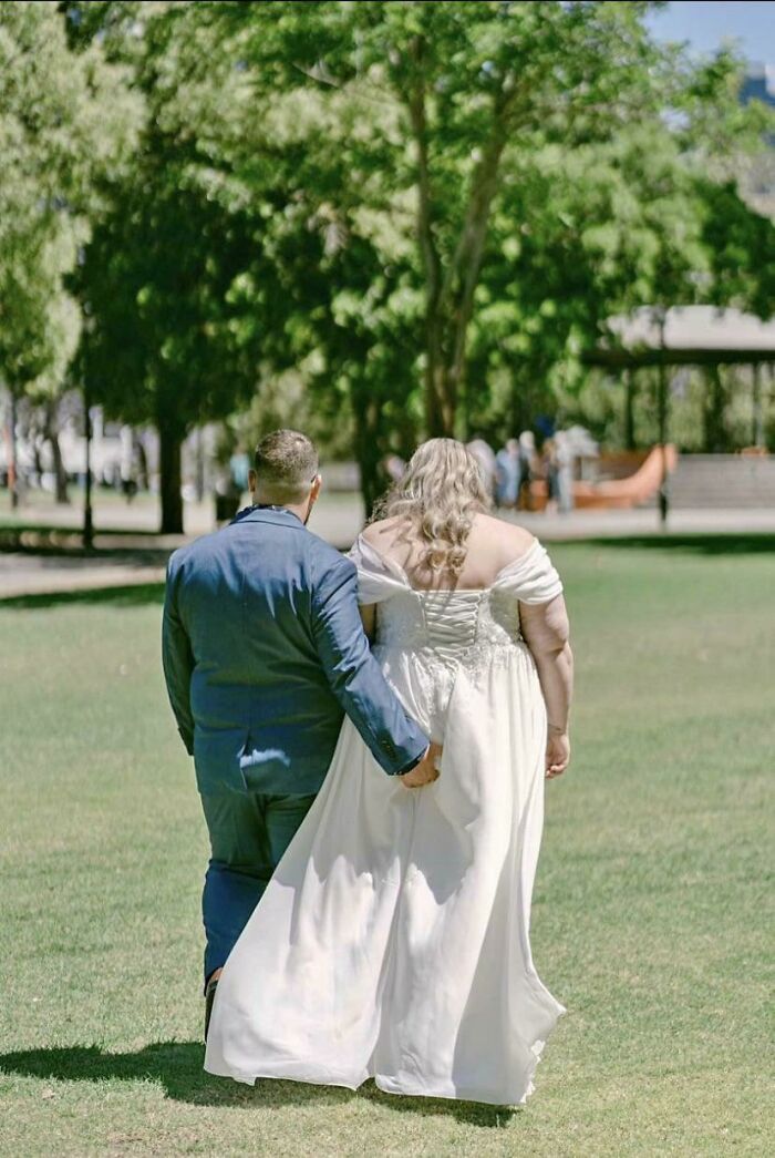 Bride and groom walking hand in hand in a park setting, part of trashy tacky distasteful wedding stories collection.