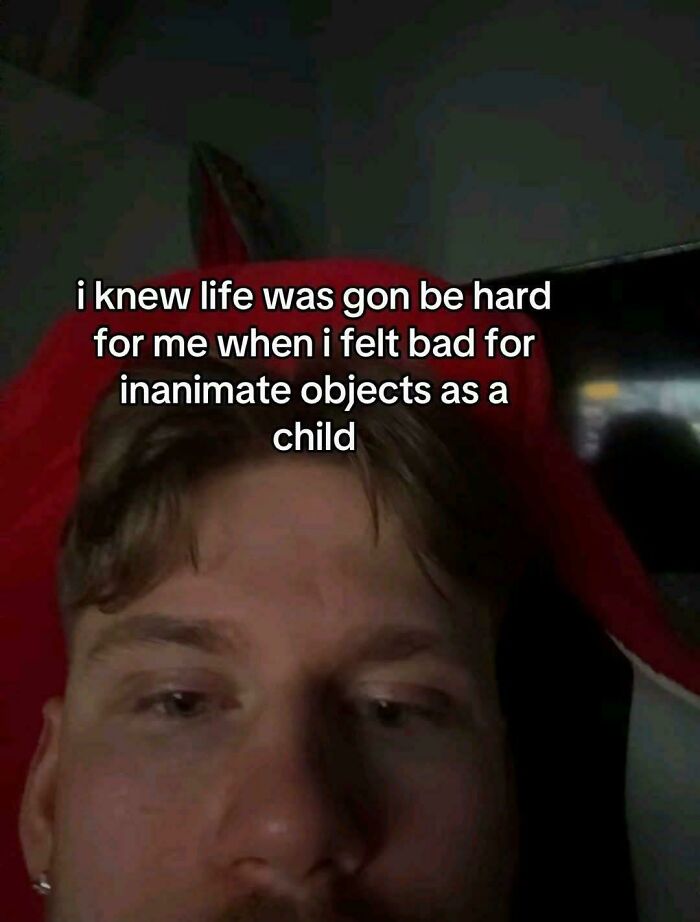 A close-up of a person's face with text overlay: "i knew life was gon be hard for me when i felt bad for inanimate objects as a child." A relatable meme about brain quirks.