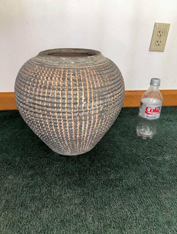 An unusual, large patterned pot next to a Diet Coke bottle, highlighting the true value of unusual possessions.