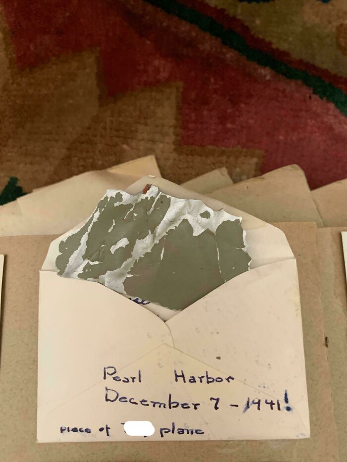 A Pearl Harbor plane fragment in an envelope, labeled with the date of attack. This unusual possession offers historical value.