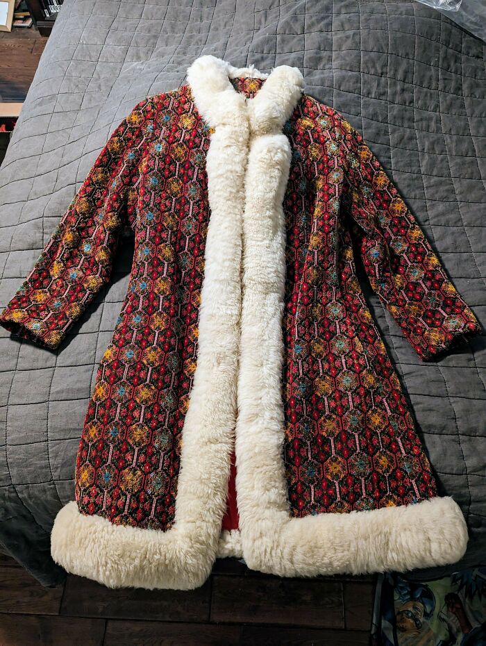 A vibrant, patterned coat with cream-colored faux fur trim. Its intricate design could be an unusual possession with true value.