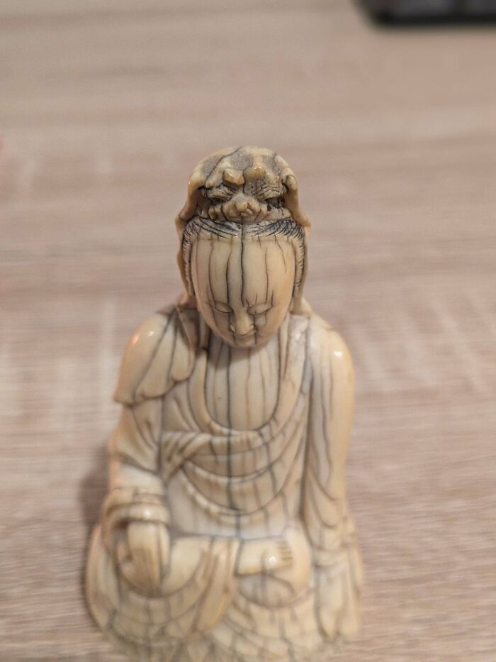 Close-up of a carved ivory figurine, showcasing its intricate details. The internet helped understand its unusual possessions value.