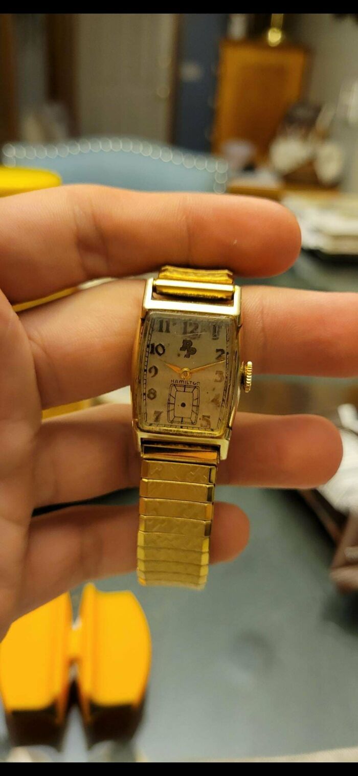 A hand holding a vintage gold Hamilton watch with an unusual dial, its value understood with internet help.
