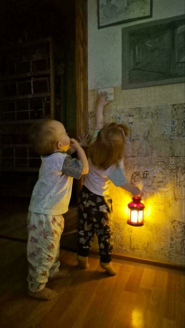 Two young kids with a lantern exploring in the dark, styled like an Accidental Renaissance painting.