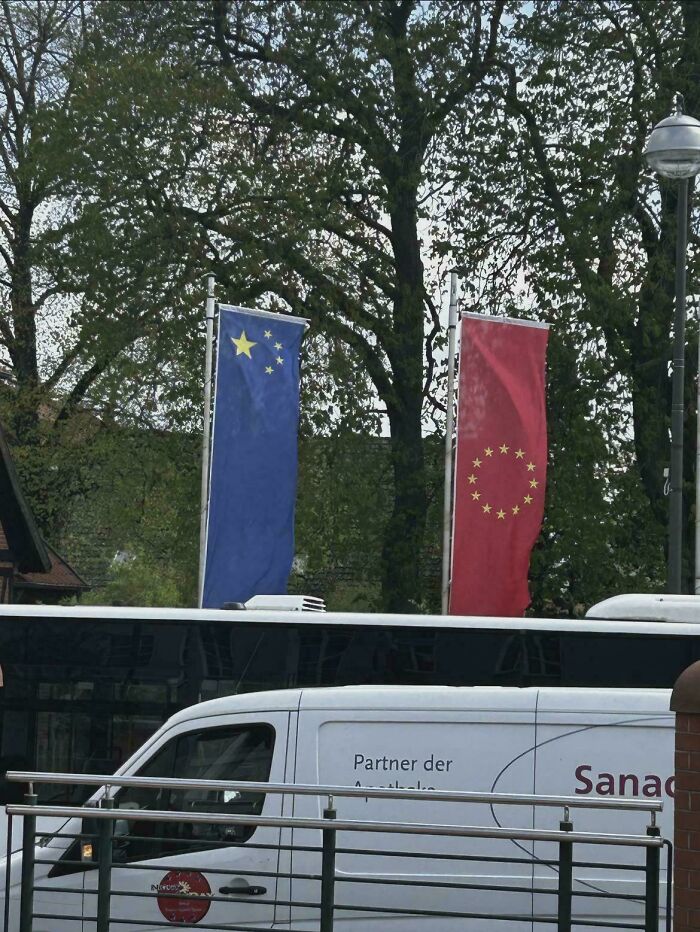 Two flags displayed incorrectly, one blue flag with stars on the left and a red flag with stars on the right, a funny fail.