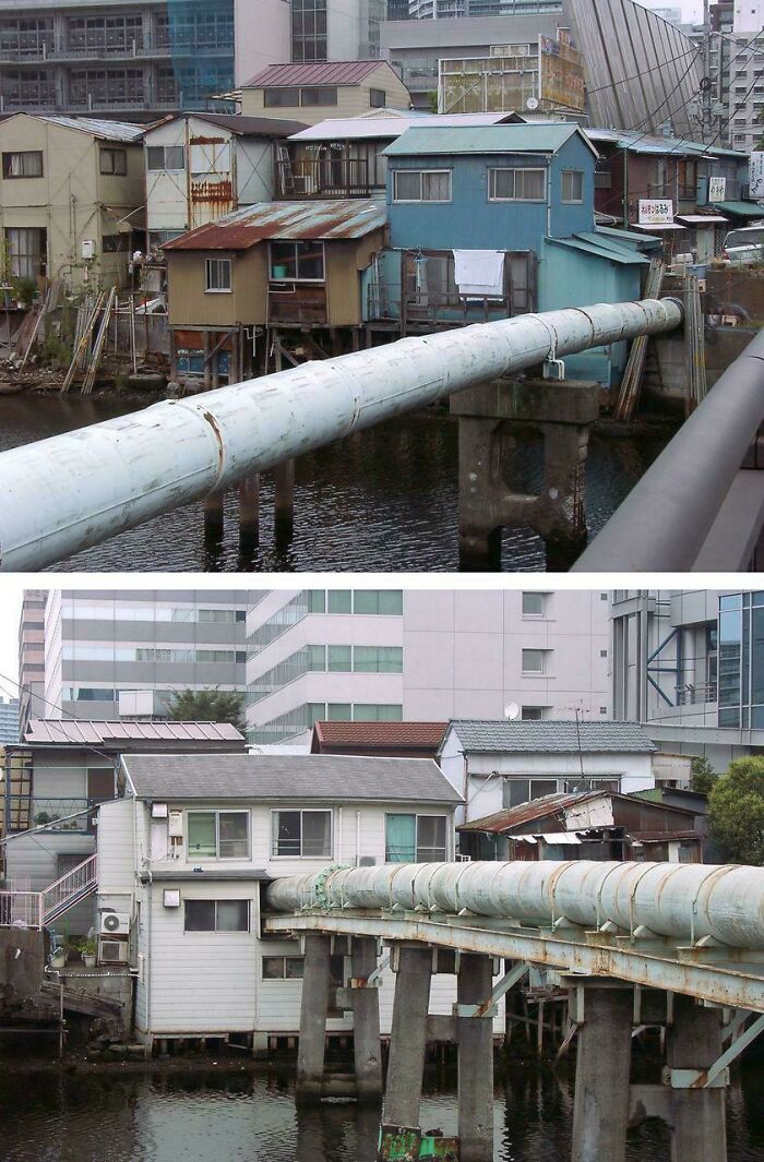 Old houses with large pipes running across water in urban hell scene