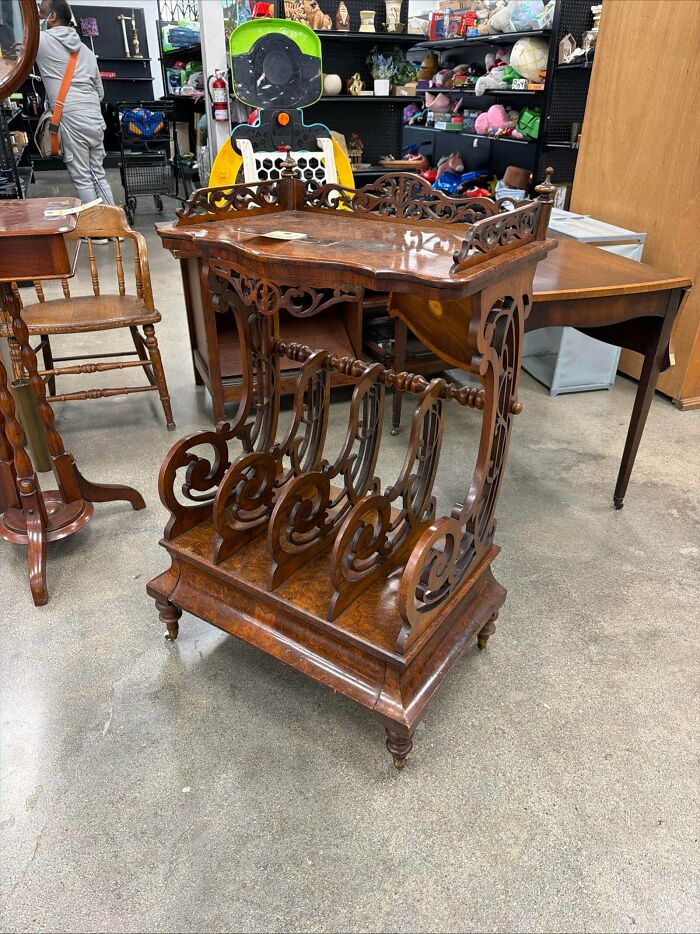 An ornate antique wooden stand, a unique thrift store jackpot piece, showcased in a store.
