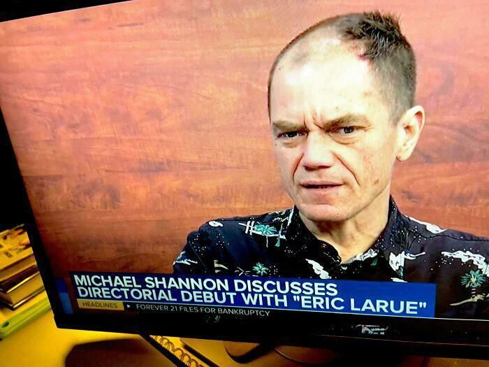 Michael Shannon on a screen with a very unfortunate haircut, discussing his directorial debut.