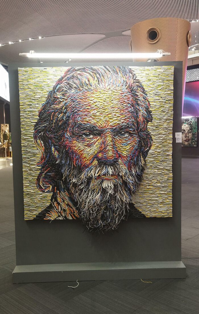 A portrait of a bearded man made from trash, specifically repurposed colorful wires. A creative person's trash into useful art.