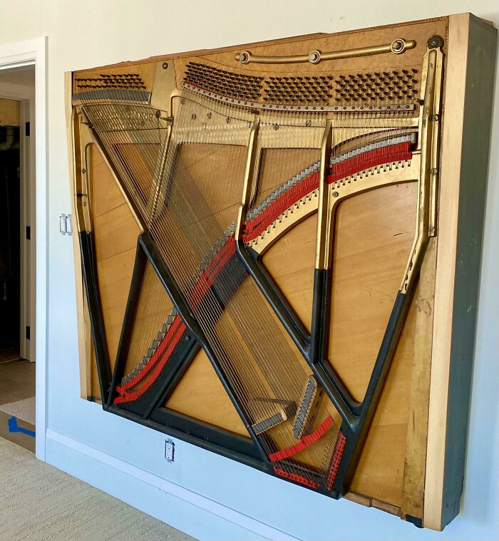 Piano soundboard transformed into surprising artistic wall decor. Creative people turn trash into art.