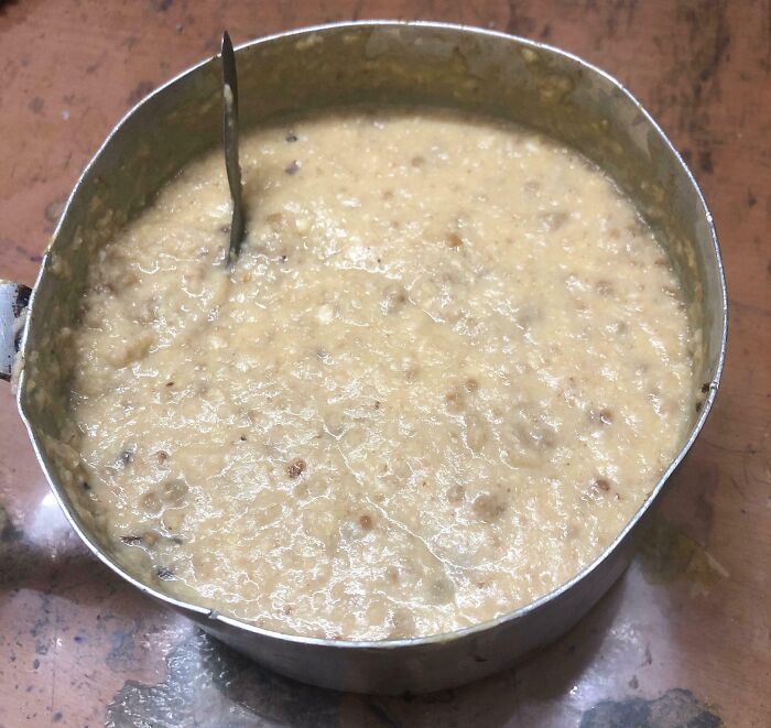 Bananasausage in a metal pot, a creamy, chunky mixture, likely one of 80 food crimes.