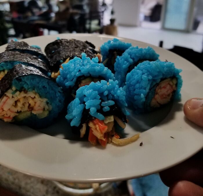 Vibrant blue sushi rolls on a white plate. This Bananasausage could be one of the Food Crimes that need a priest.