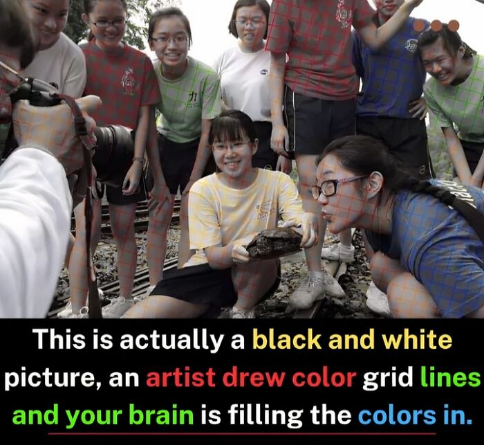 Group of smiling students examining a rock, illustrating how the brain fills color in a black and white photo with color grid lines.
